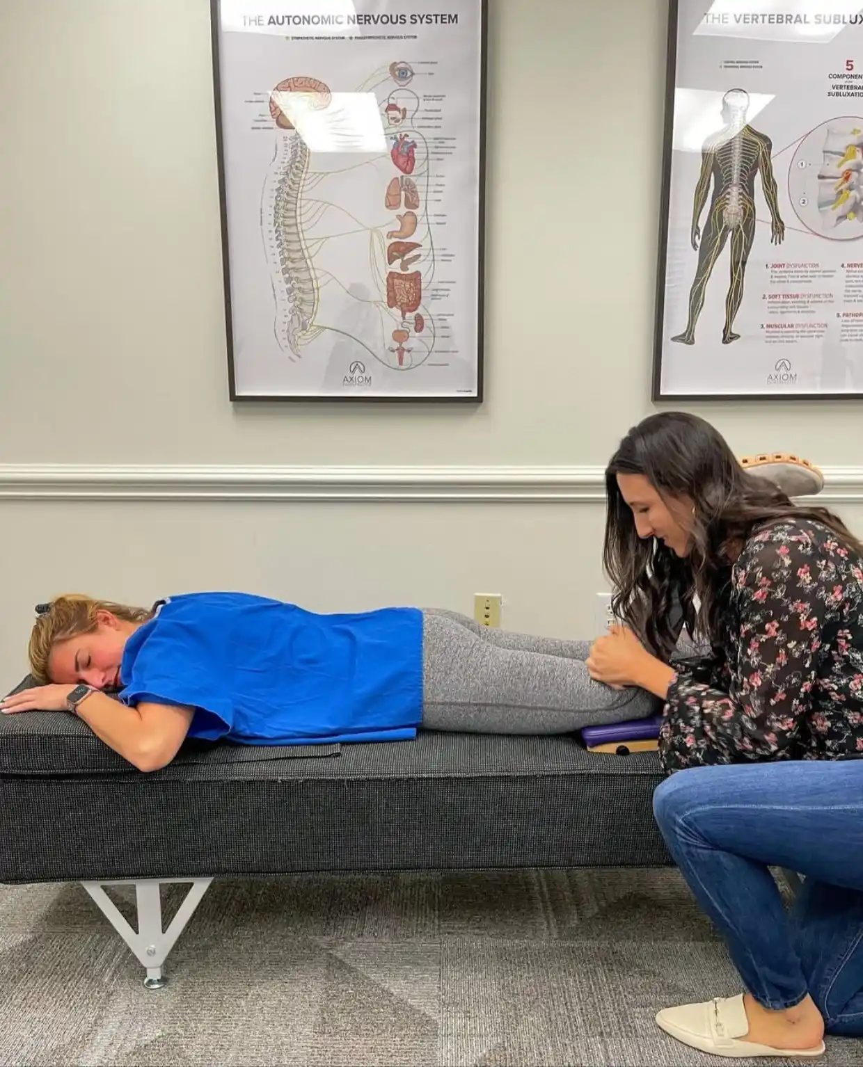 Chiropractor performing a lower Sciatica alignment adjustment on a patient at Axiom Chiropractic in Charlotte NC