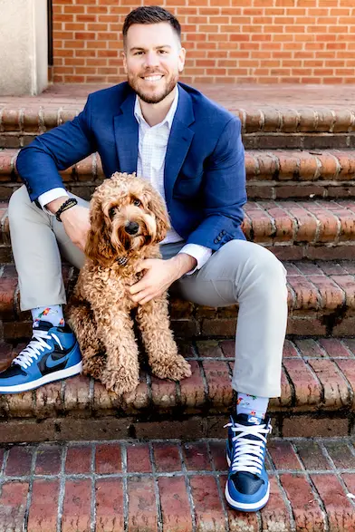 Dr. Tyler Sitting with Dog at Axiom Chiropractic