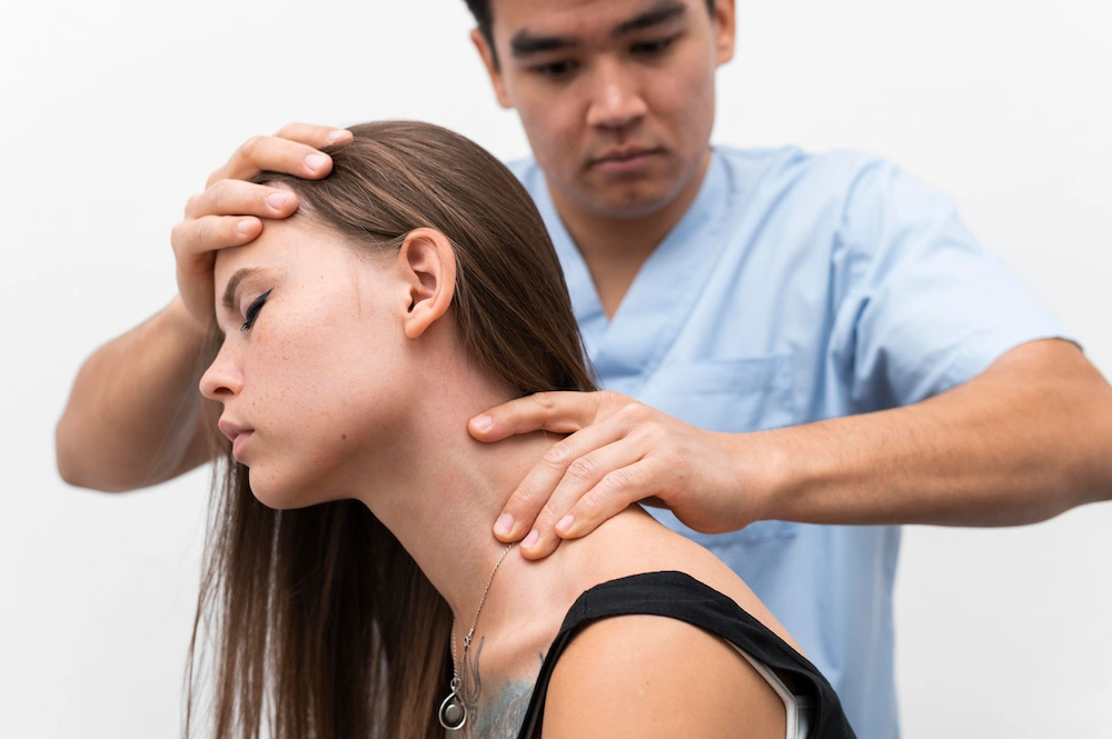 Chiropractor treating woman for whiplash neck injury