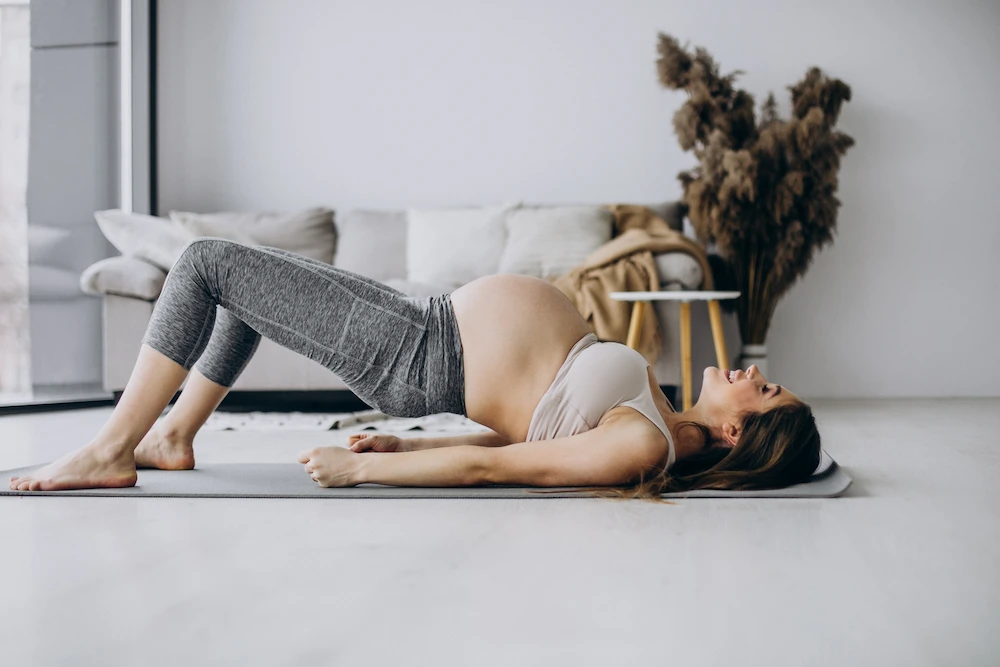Pregnant woman receiving chiropractic care to relieve sciatica and lower back discomfort