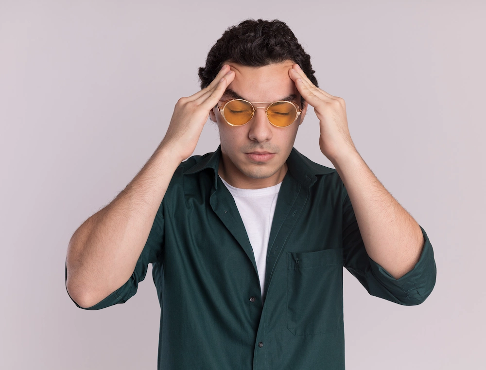 Person holding head and feeling dizzy due to neck problems